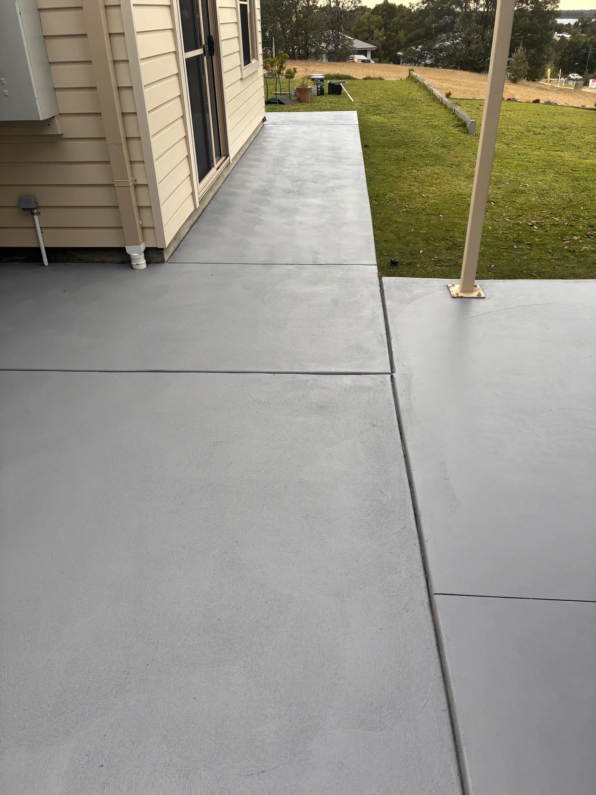 Freshly cleaned concrete driveway and paths around a home